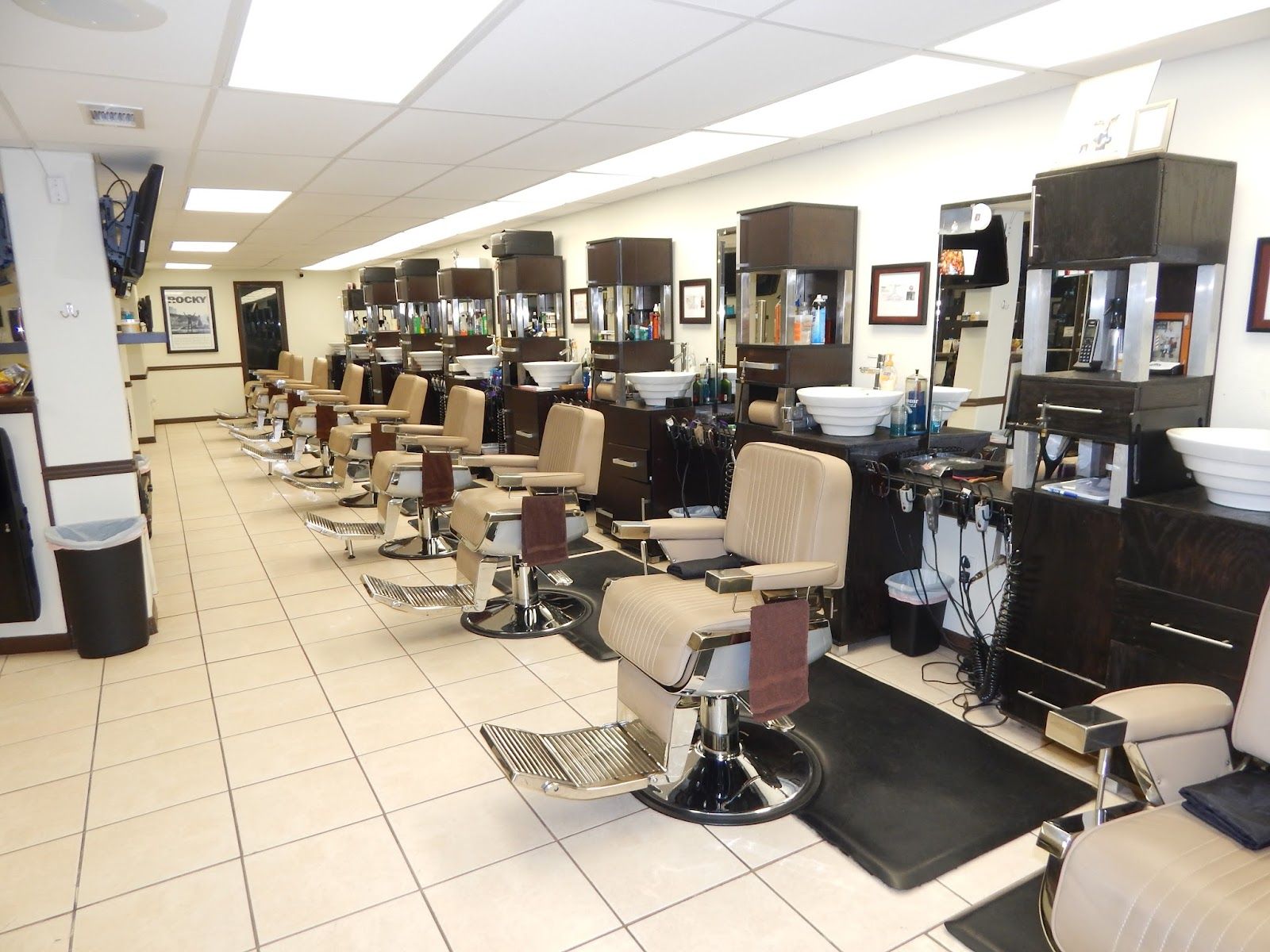 The Ocala Rd shop floor: barber chairs down one side, mirrors, sinks and shelves of product.